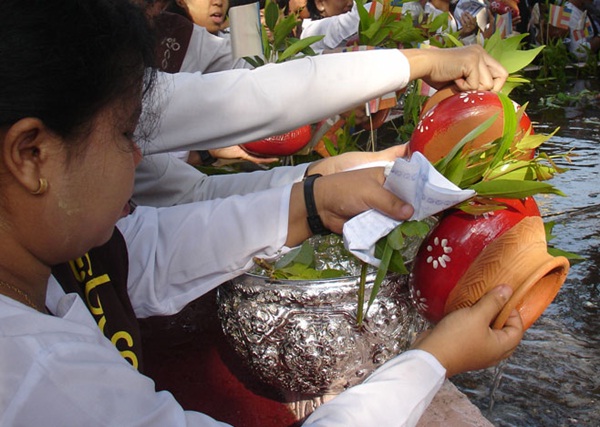 People releasing live fish into the river