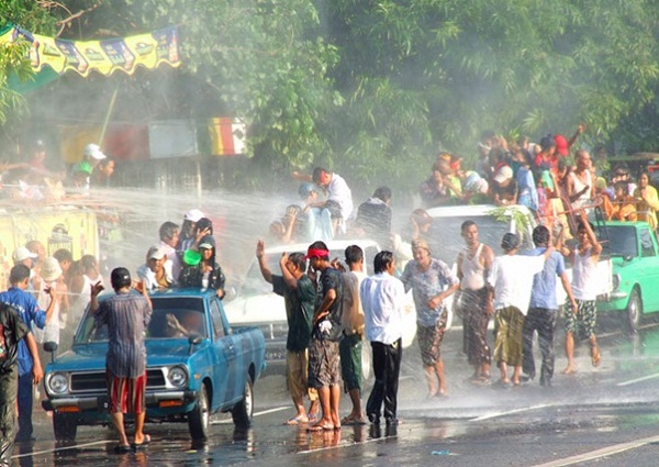  People with cars and trucks used to play water