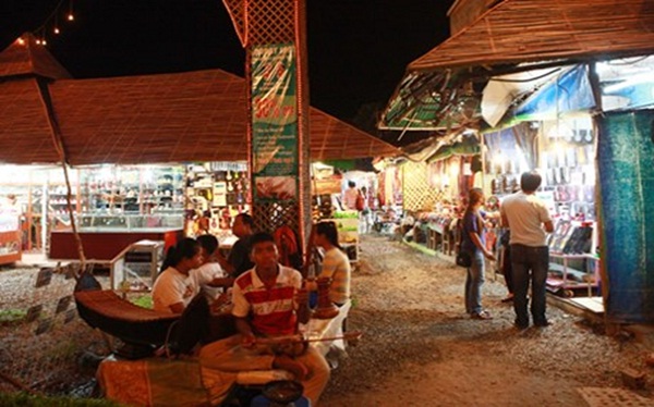 Local musicians are playing traditional instruments at the gate of the market