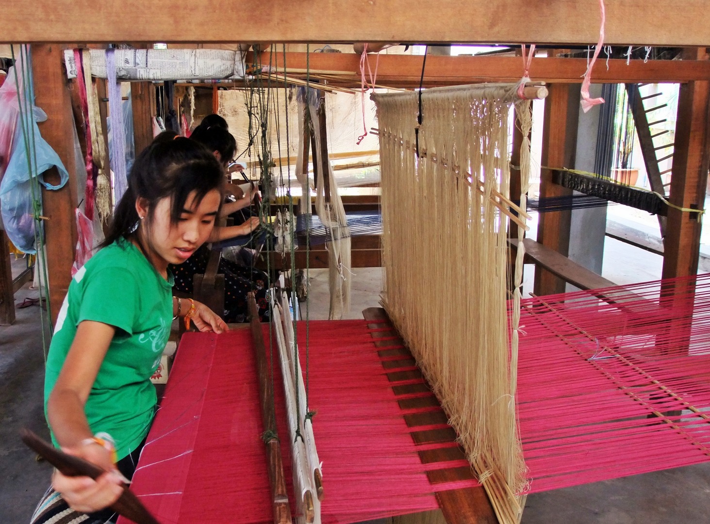 Women waving in Carol Cassidy Lao Textiles