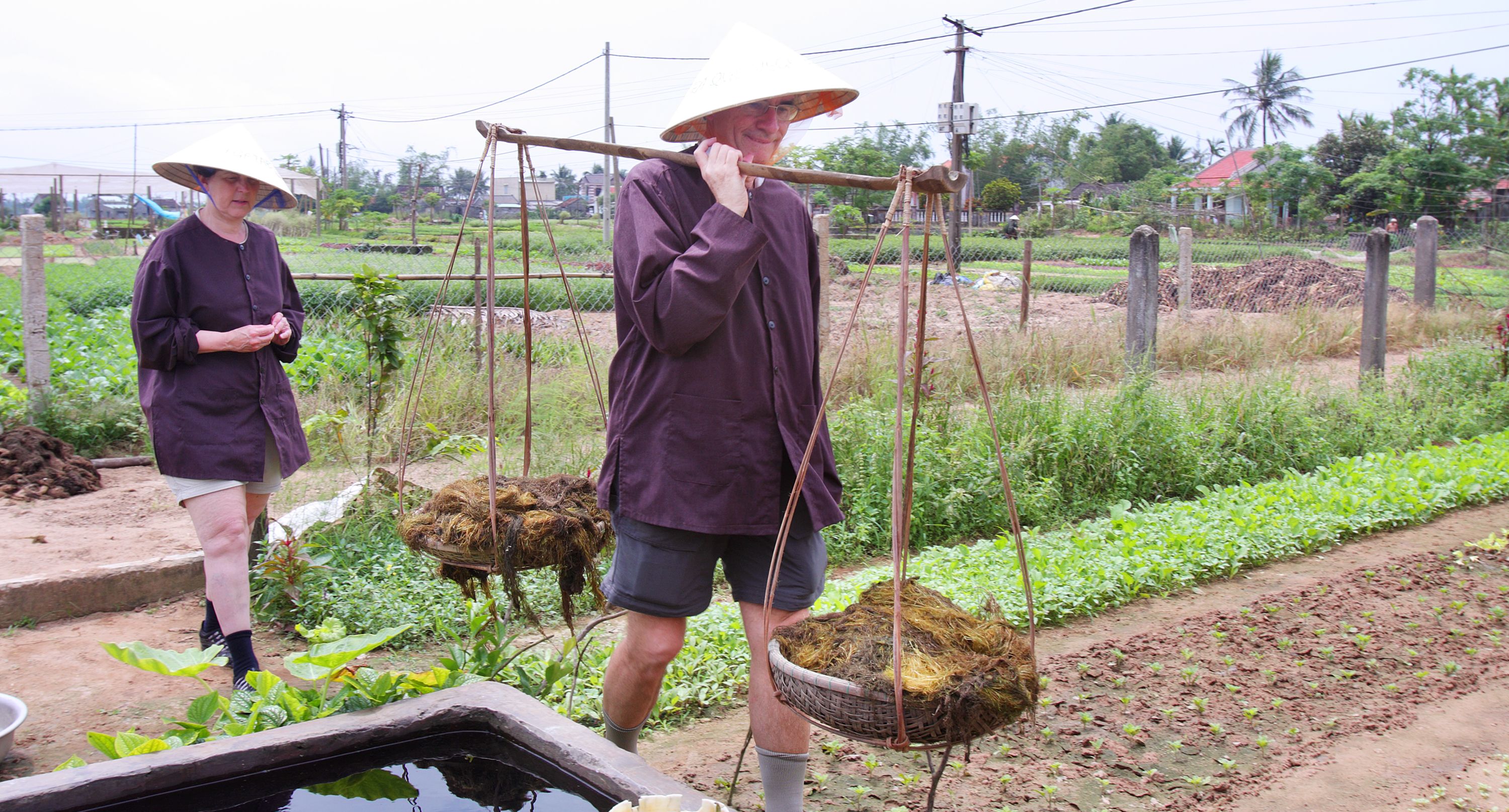 Tourists experiencing as a local farmer in Tra Que Village