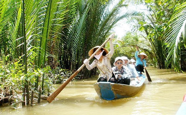 Tourists on a small boat weaving its way on small waterways