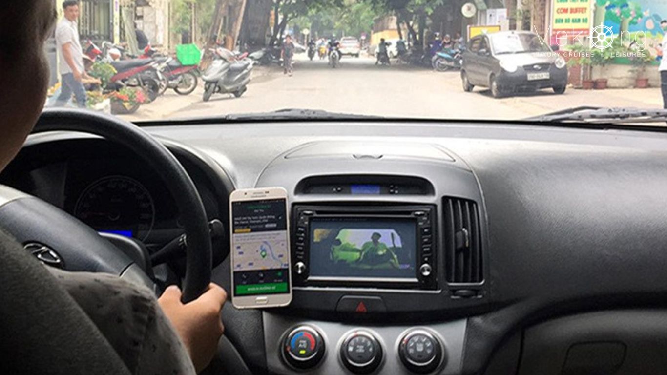 A person driving a car with the ride-hailing app on their phone