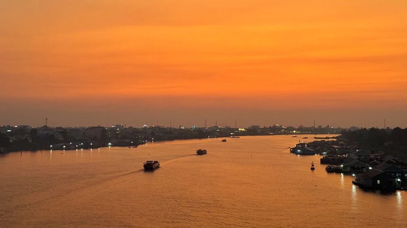Chau Doc sunset over the Hau River with boats and floating villages along the Mekong Delta gateway to Cambodia Vietnam